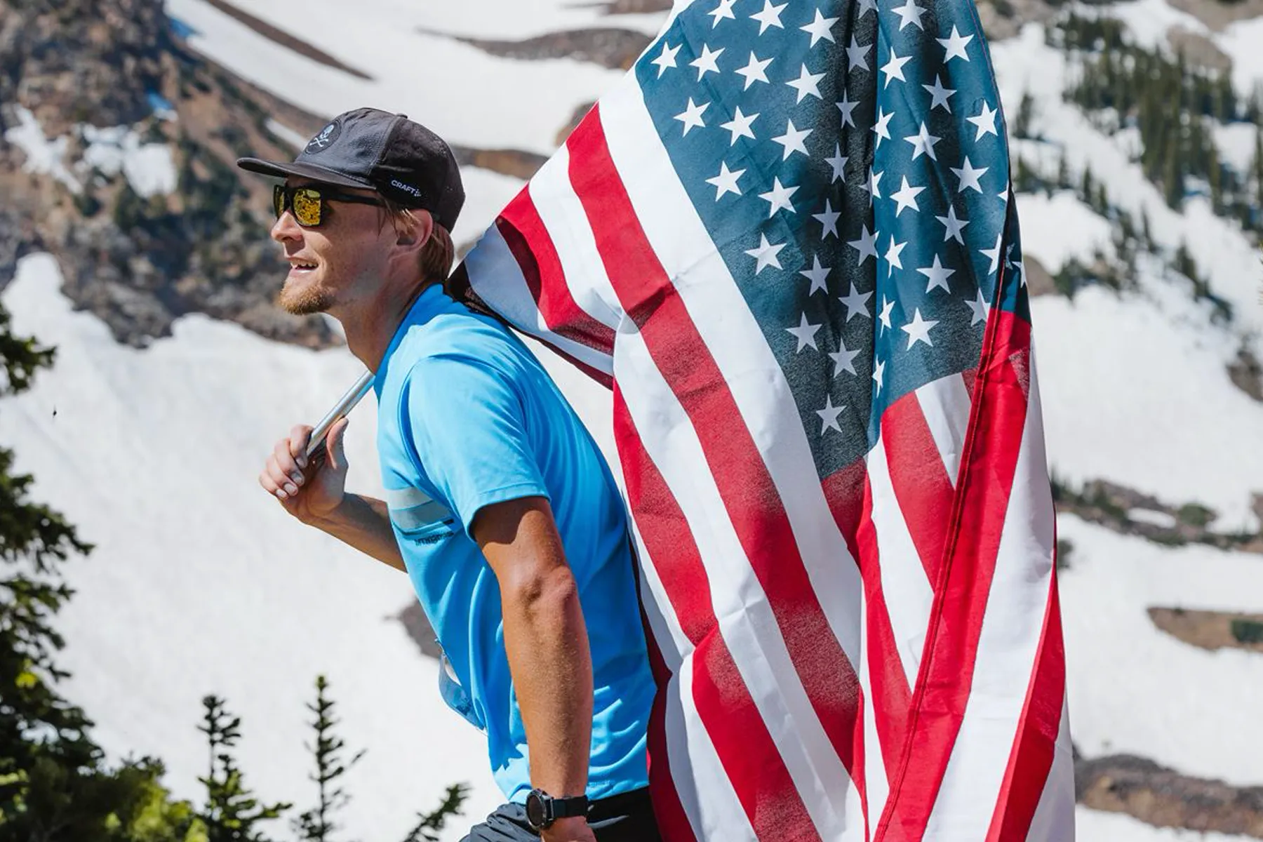 Cougar Kyle Burgess MTN OPS Fitness lead photo running with American Flag