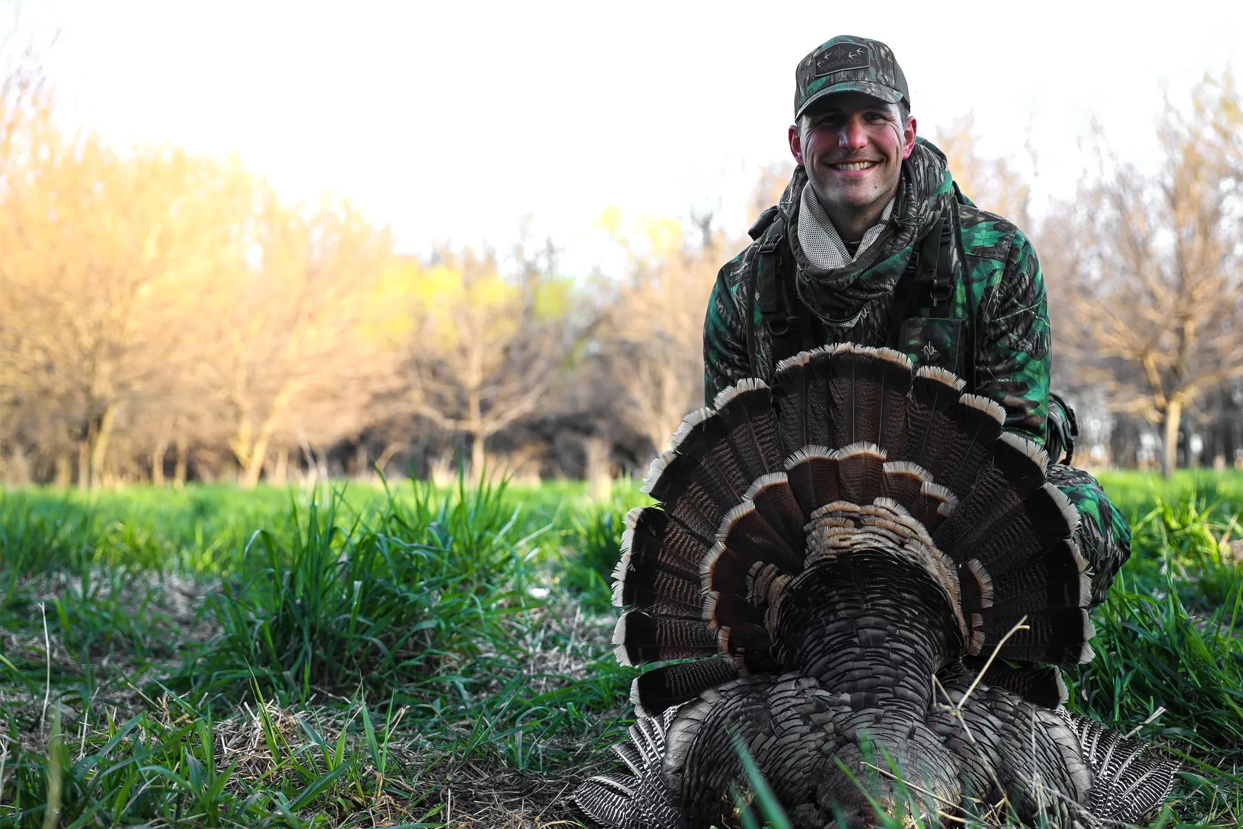 Justin Adams author bio photo with a downed wild turkey