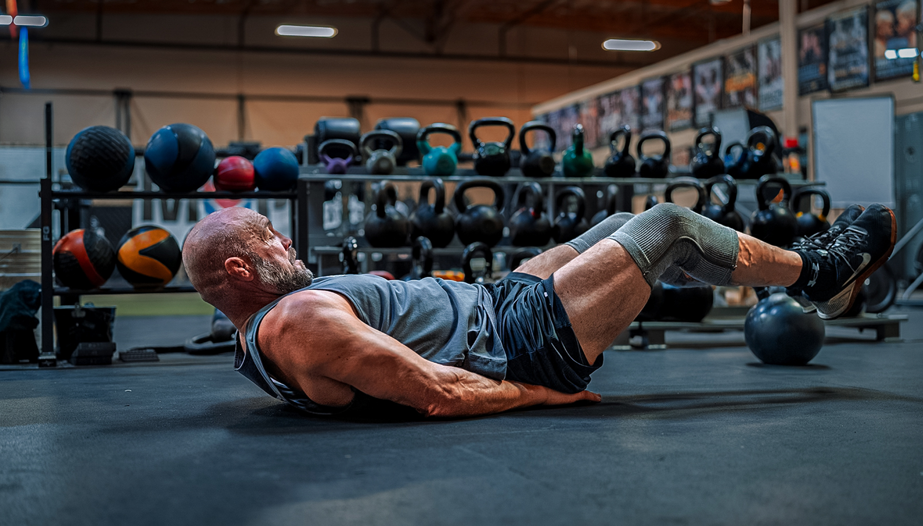 Randy Couture doing leg raises in a gym