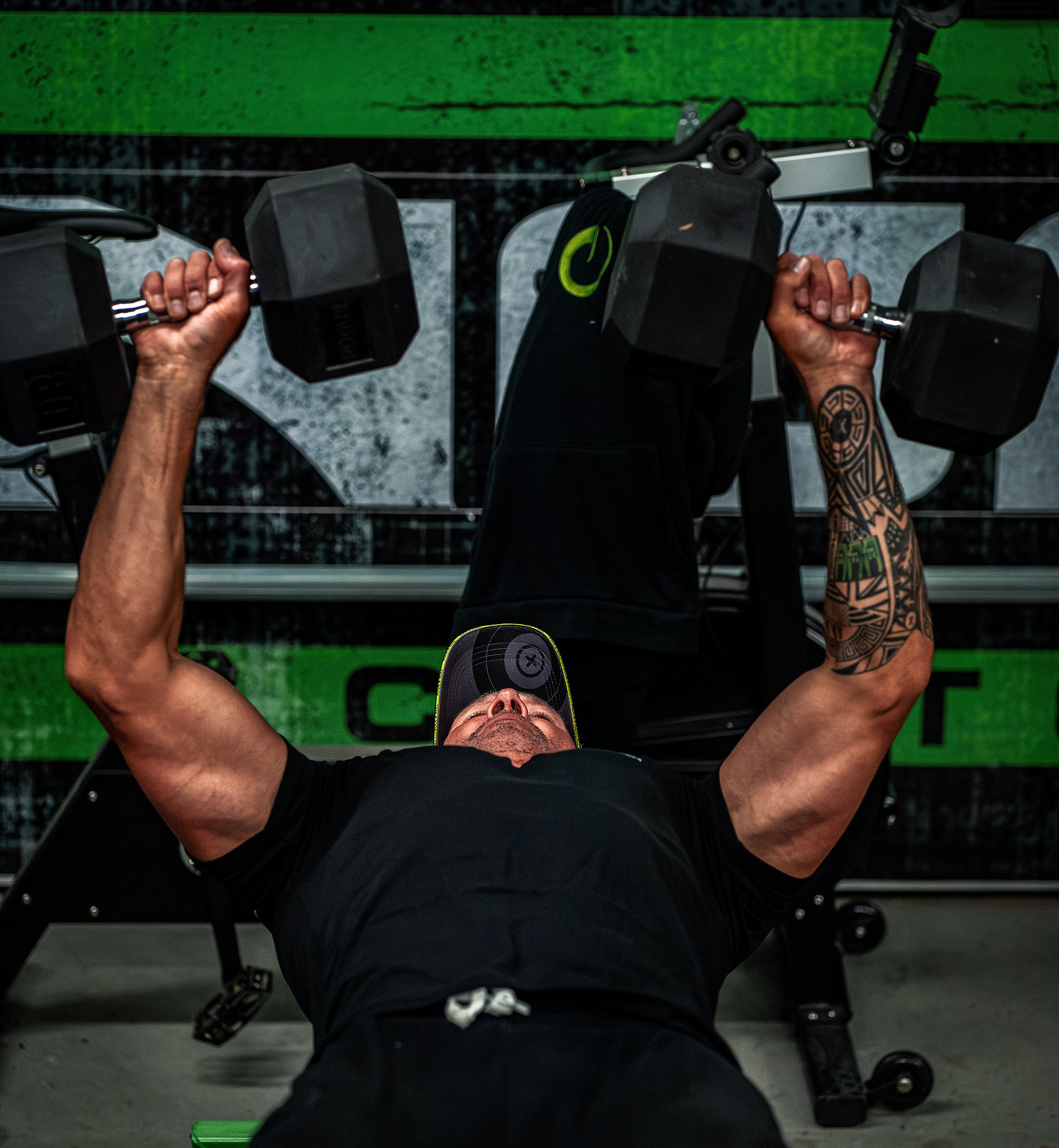 John Dudley doing dumbbell presses