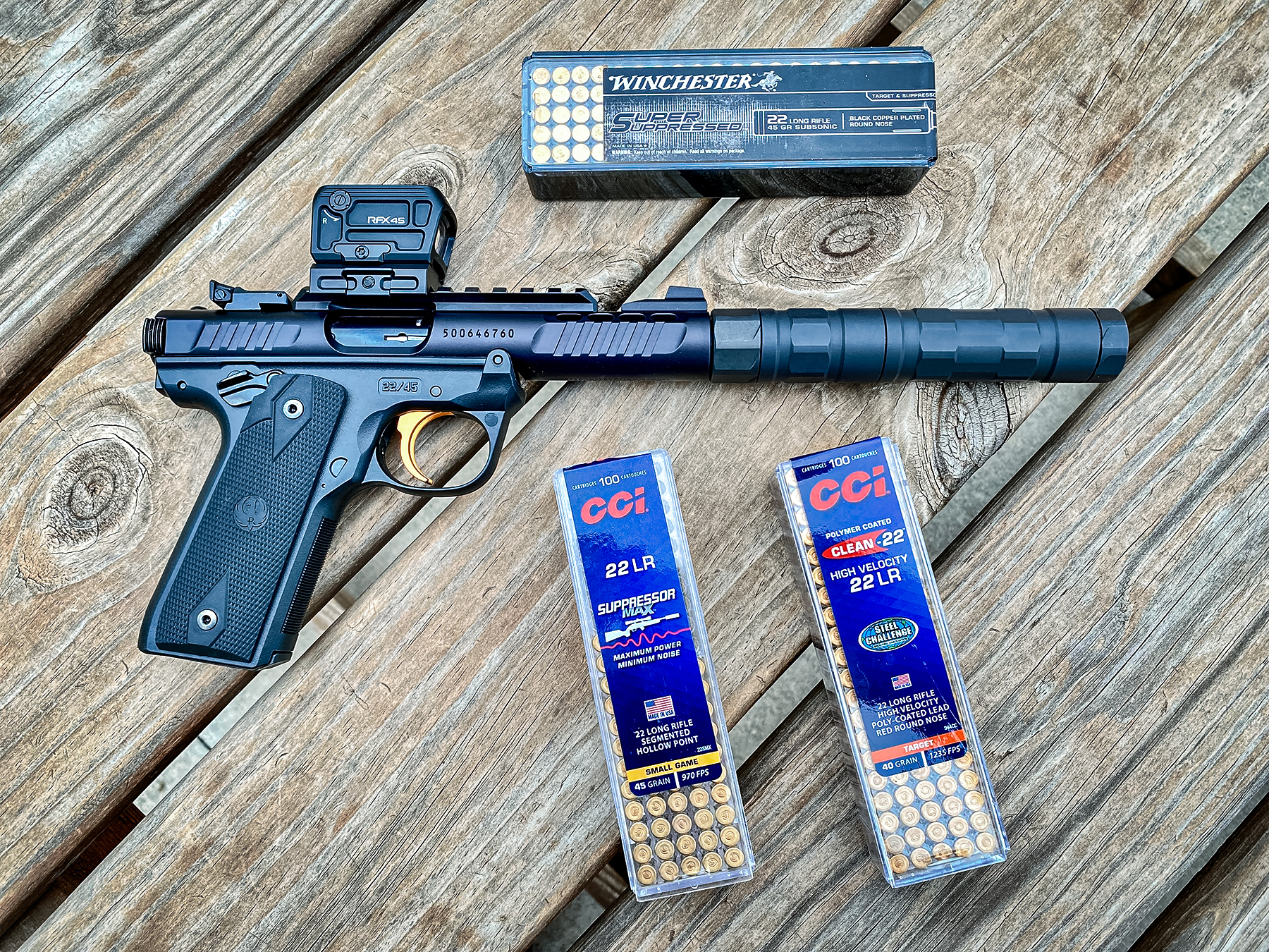 Ruger Mark IV 22/45 Lite with various .22LR ammo in boxes including Winchester and CCI