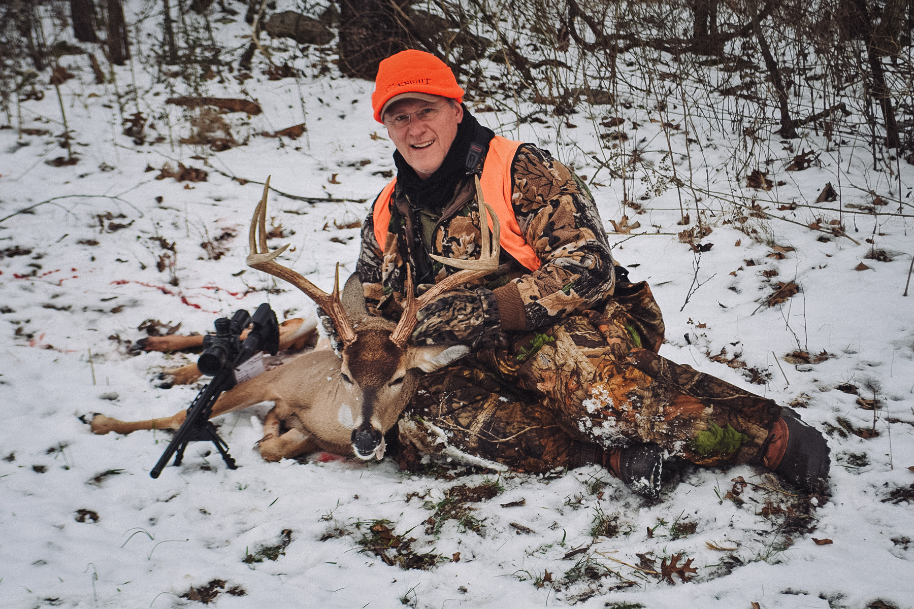 Barnes Harvest hunting ammunition a hunter with a large buck