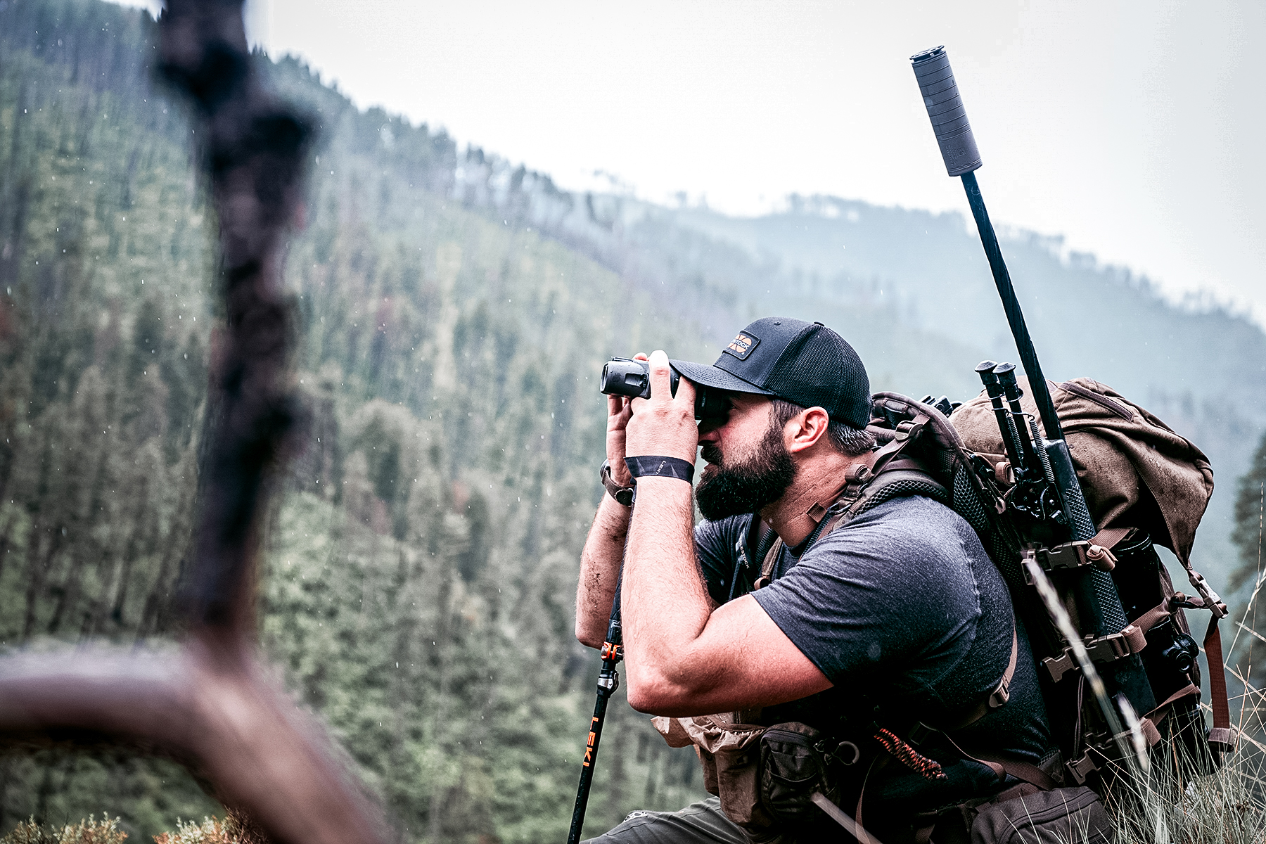 hunter with a SilencerCo Scythe-Ti suppressor topped rifle in his pack