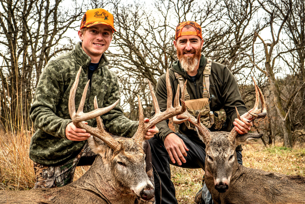Adam LaRoche with his son and two giant whitetails