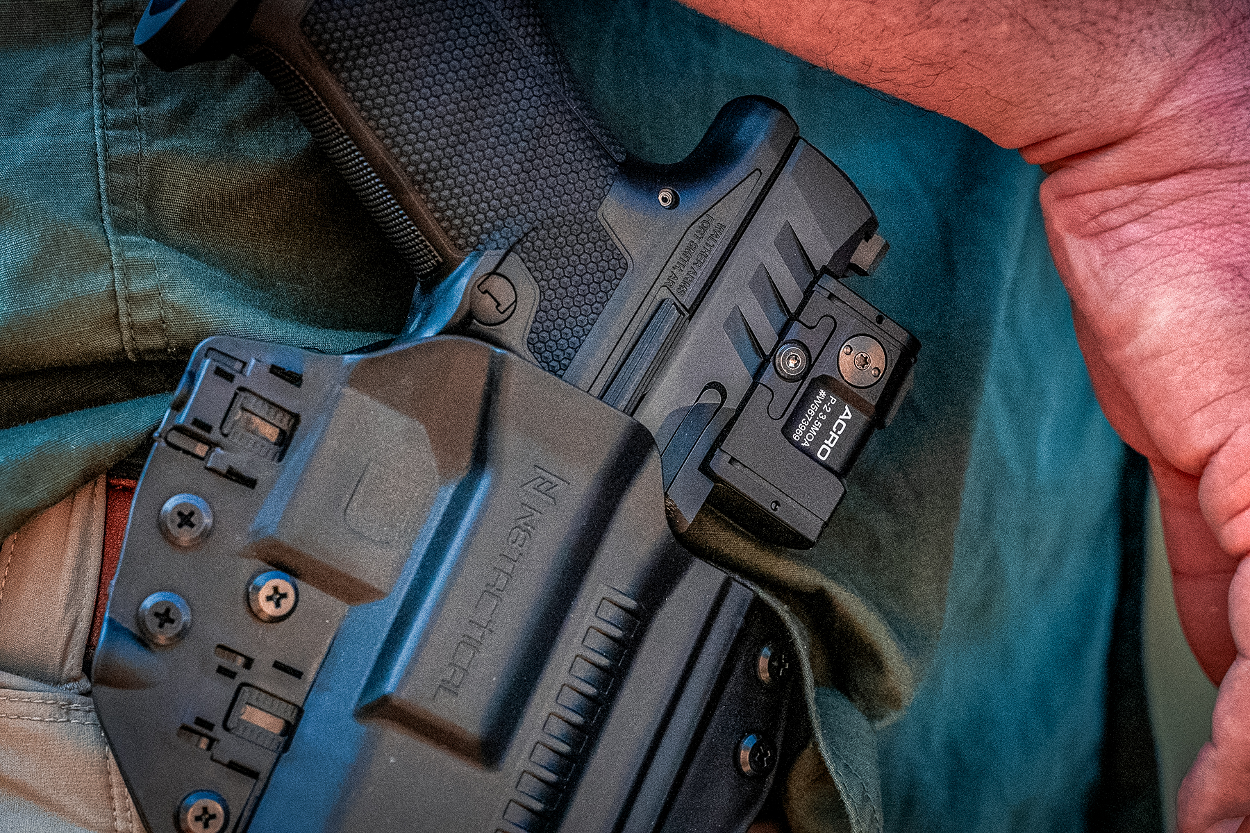 the walther in a holster with an ACRO red dot installed