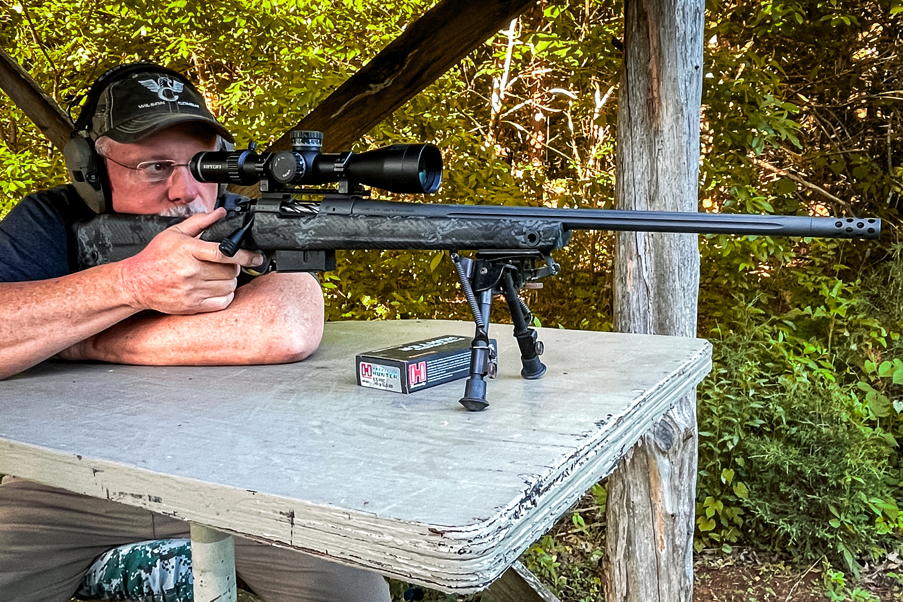 a man shooting a 6.5 PRC rifle