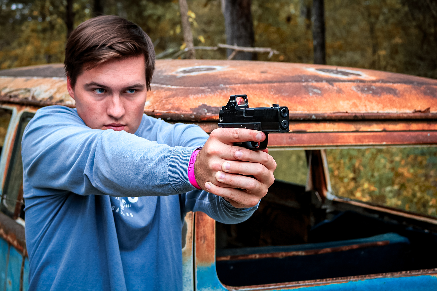 a man shooting an LTT Hellcat Pro pistol