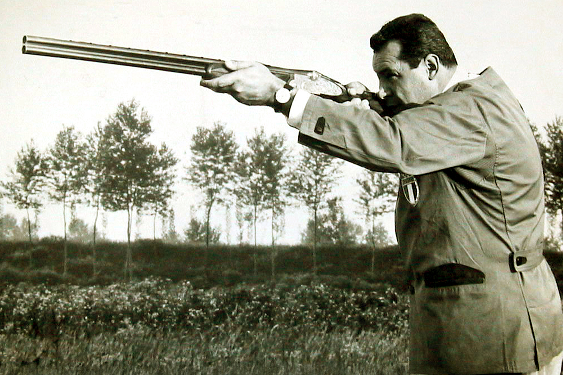 man shooting an over under shotgun in the 1956 Olympic Games