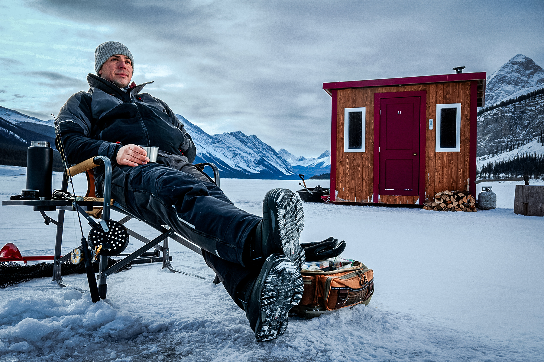Carey Price NH goalie sitting outside of an ice fishing shanty