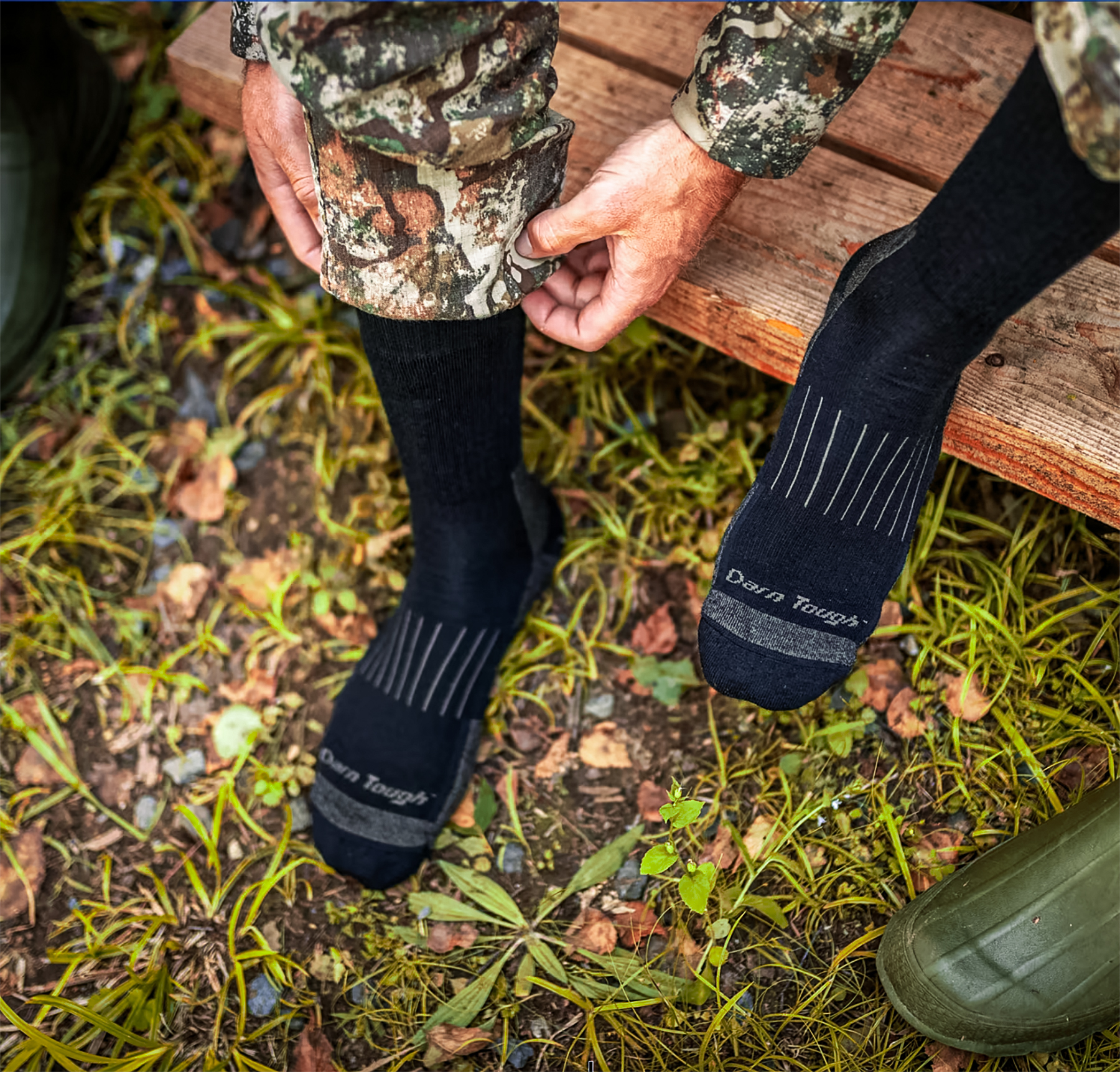 a hunter putting on darn tough socks