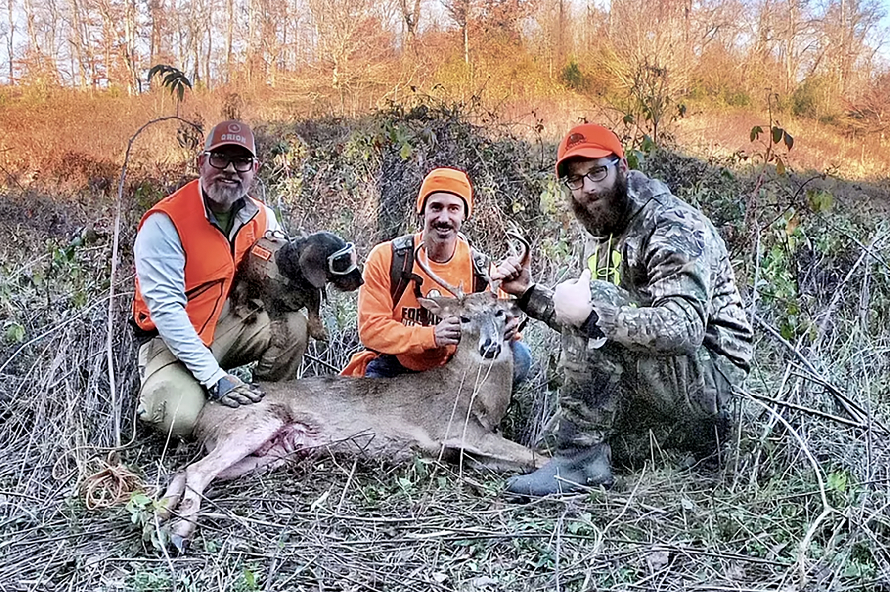 jaeger the deer tracking dog wiht hunters and a downed buck