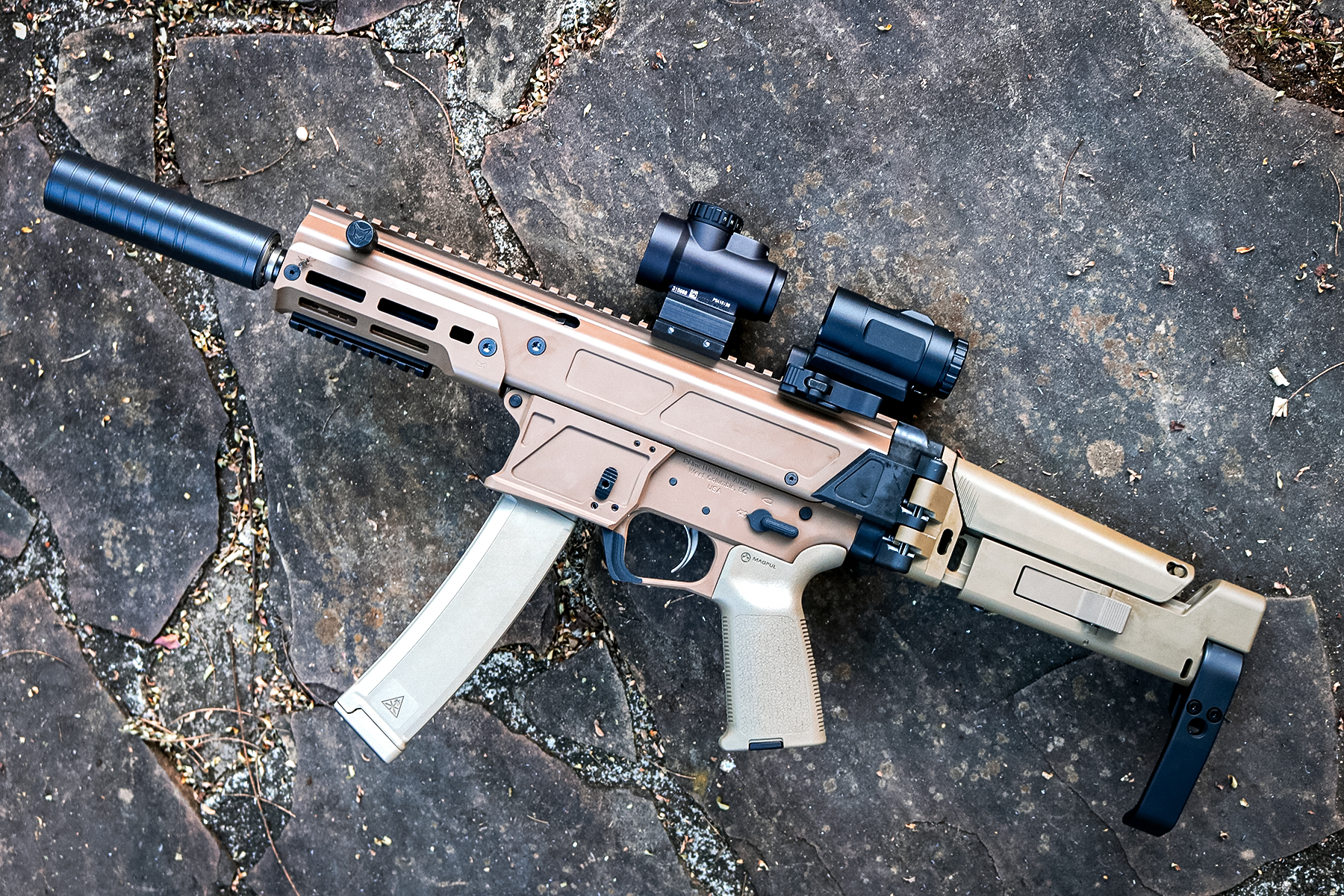 PSA JAKL 9 outfitted with a red dot and magnifier, suppressors, and pistol brace