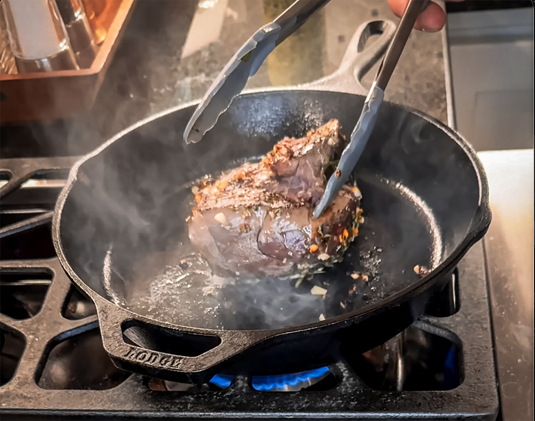 searing venison roast in a cast iron pan