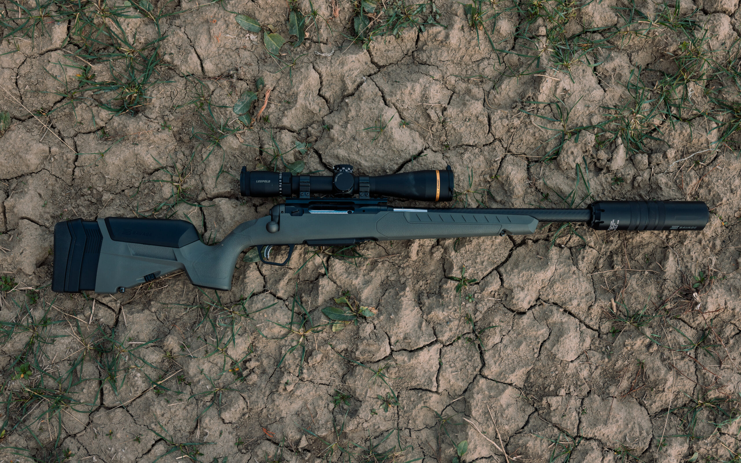 The Savage 110 Carbon Hunter lays in the dirt.