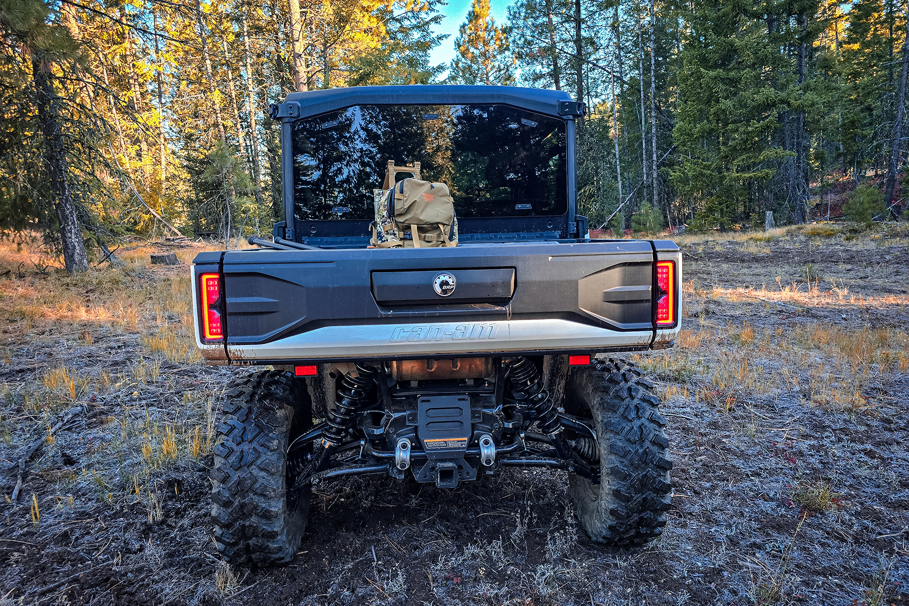 Can-Am Defender from the rear with a hunting pack in the bed