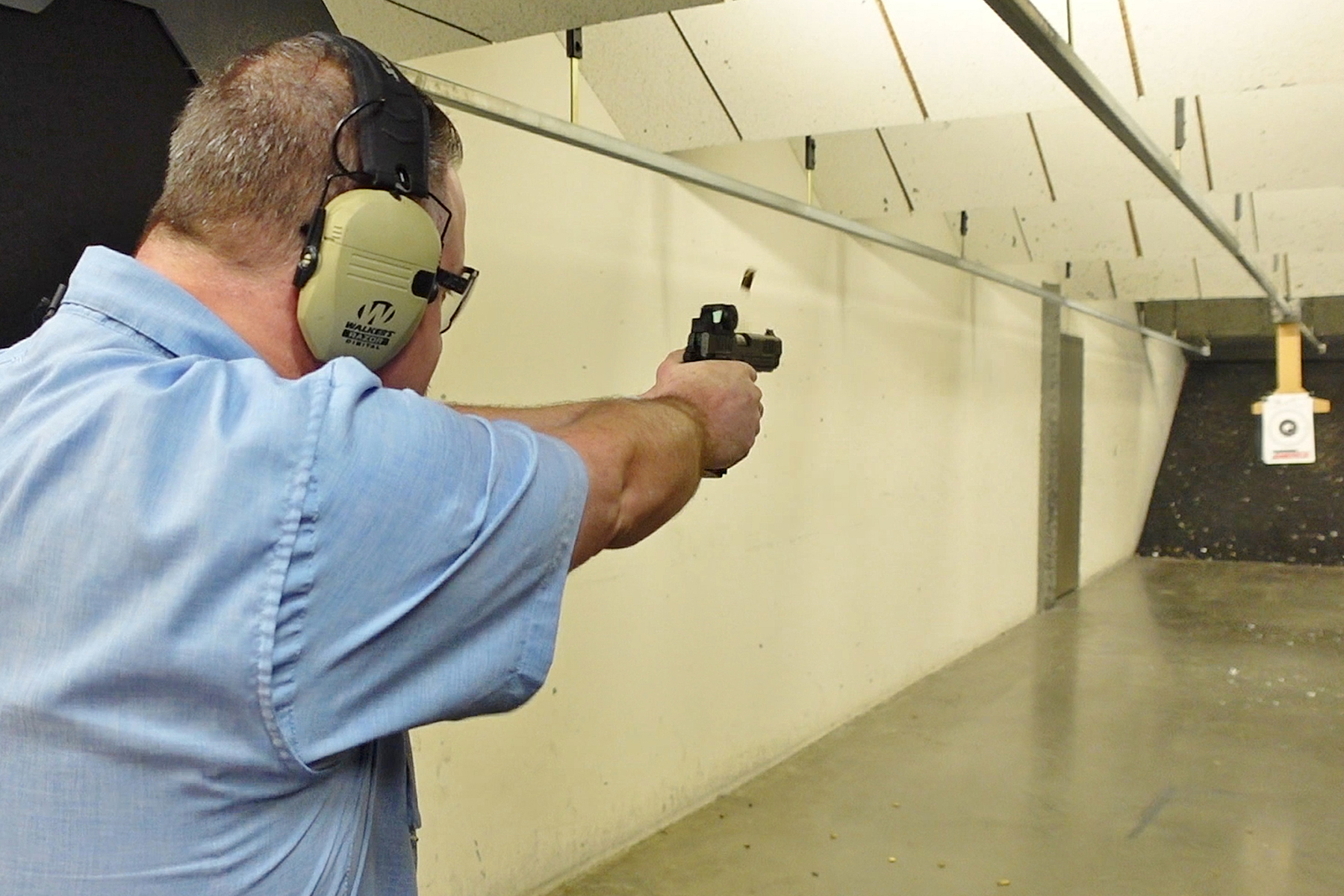 EOTECH EFLX CE Mini Reflex Sight on a pistol being fired at the range