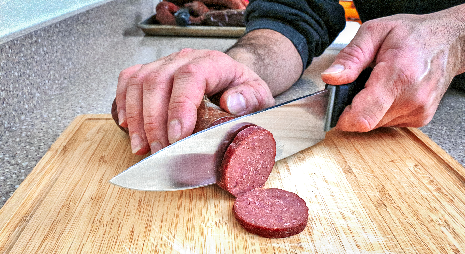 slicing sausage with a knife