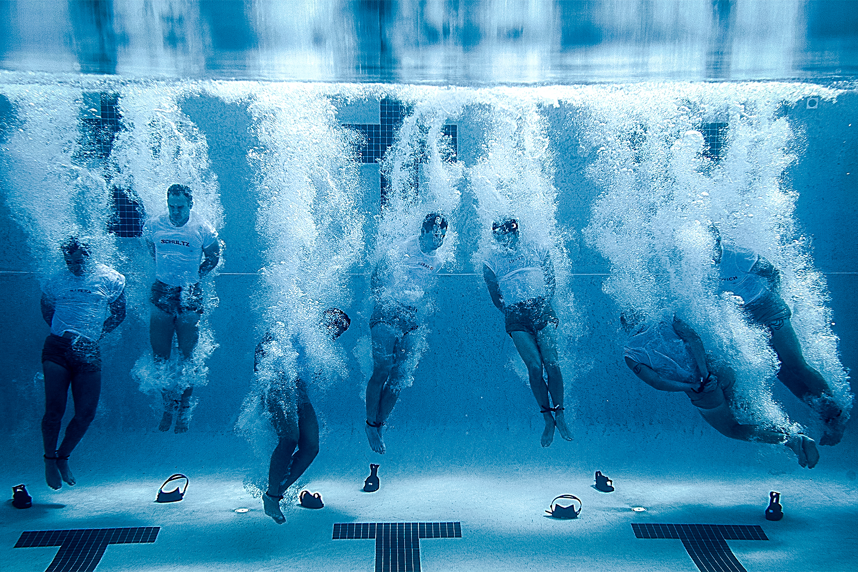 military members training in a pool