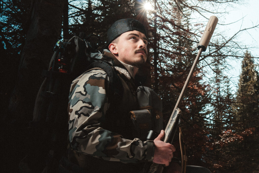 Hunter with Dead Air Nomad Ti OTB suppressed hunting rifle
