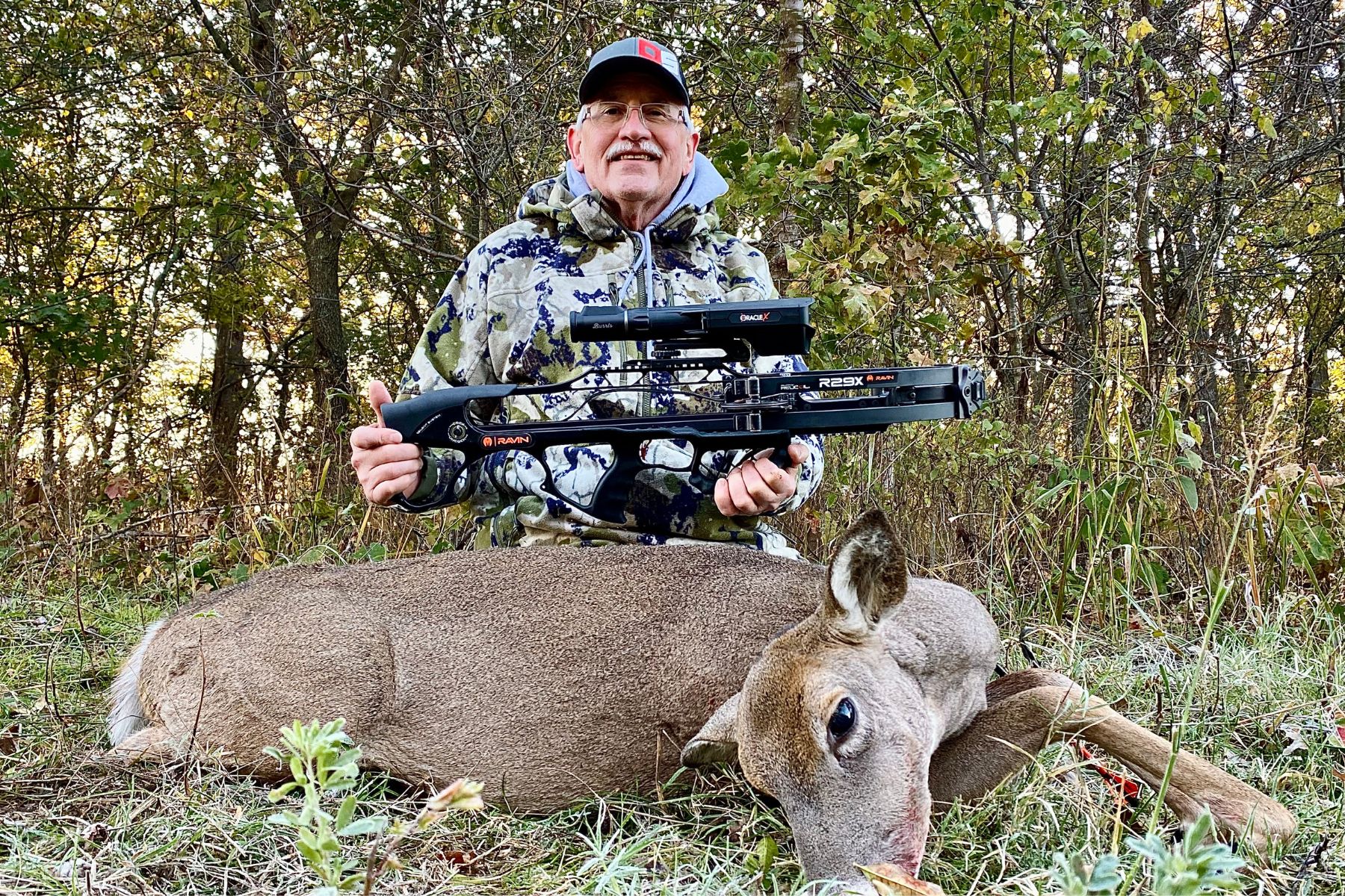 A hunter poses with a doe and a Ravin crossbow while on a hunt sponsored by Outdoor Solutions.