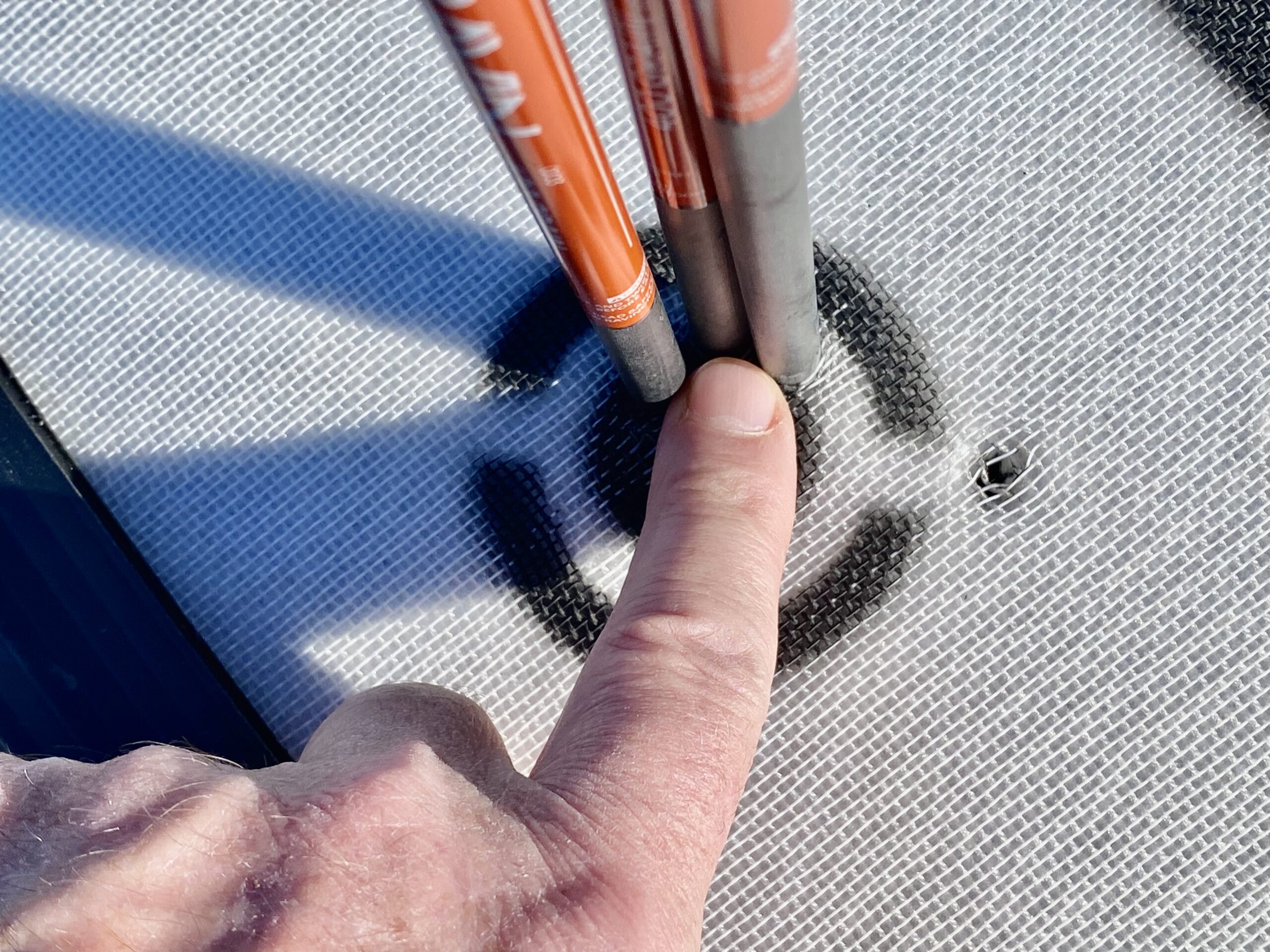 A finger points to three arrows in a target bullseye.