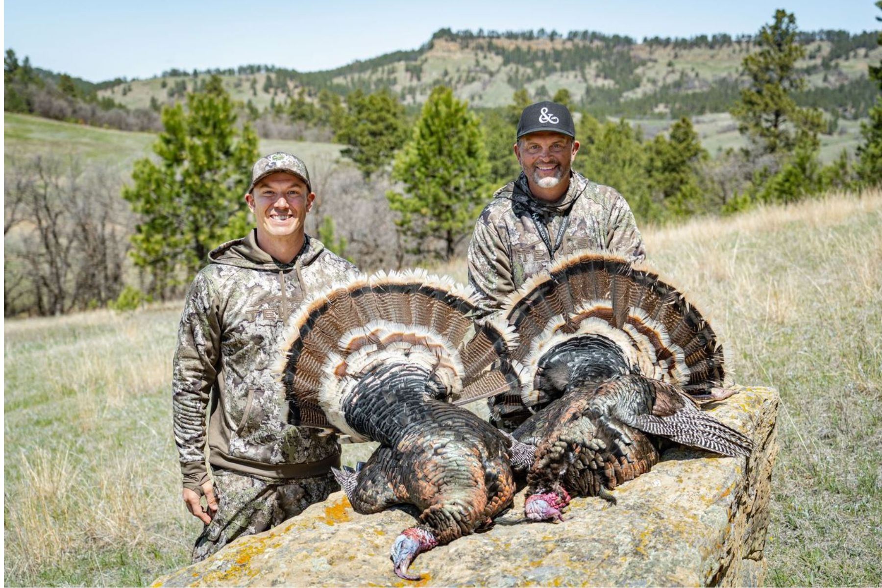 John Radzwilla and Michael Waddell pose with two Merriam's turkeys.