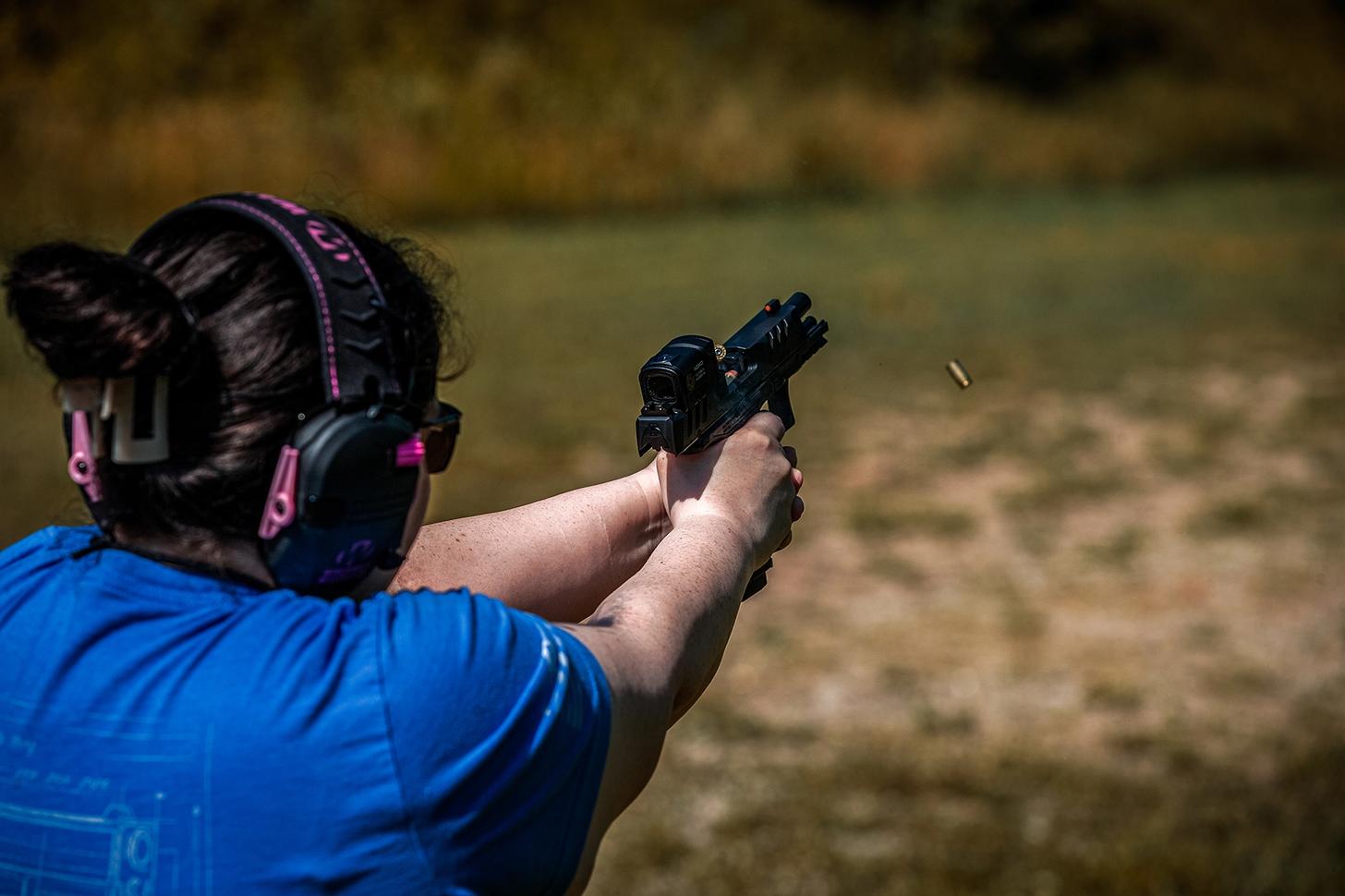 A woman firing the Walther PDP F Pro ACRO