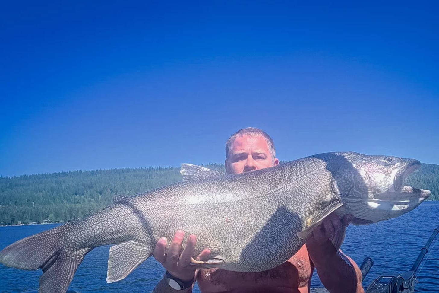Aaron Goettsche with the new Idaho State Record Lake Trout he caught in July 2025 - Idaho Fish and Game