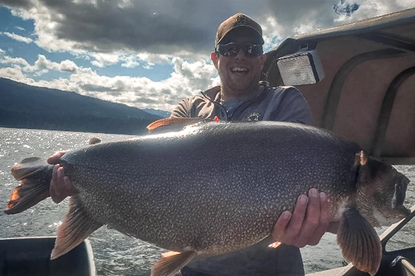 Aaron Goettsche with the new Idaho State Record Lake Trout he caught in July 2025 - Idaho Fish and Game