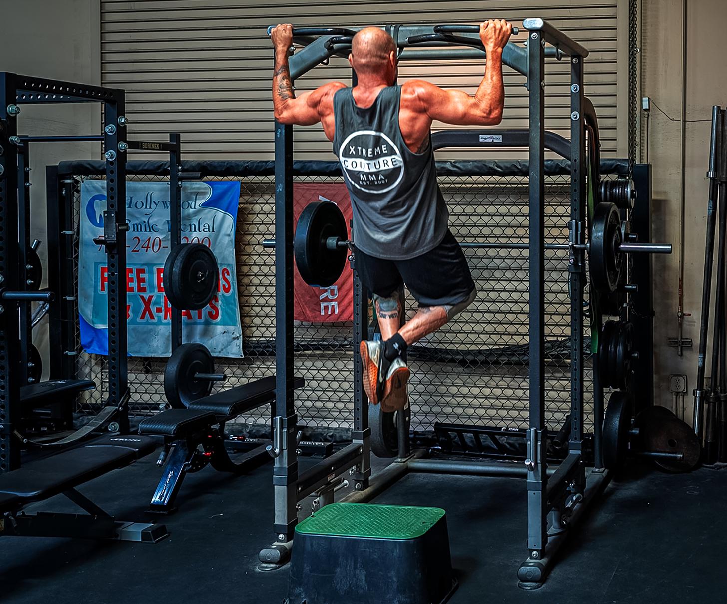 Randy Couture doing pull ups in the gym