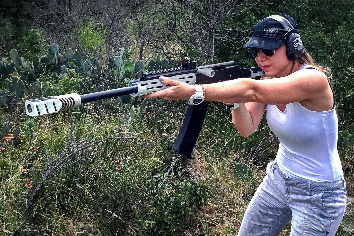 A woman shooting a custom Saiga 12 semi-auto shotgun
