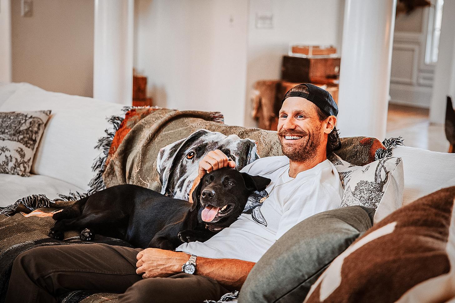 Chase Rice with his dog on the couch