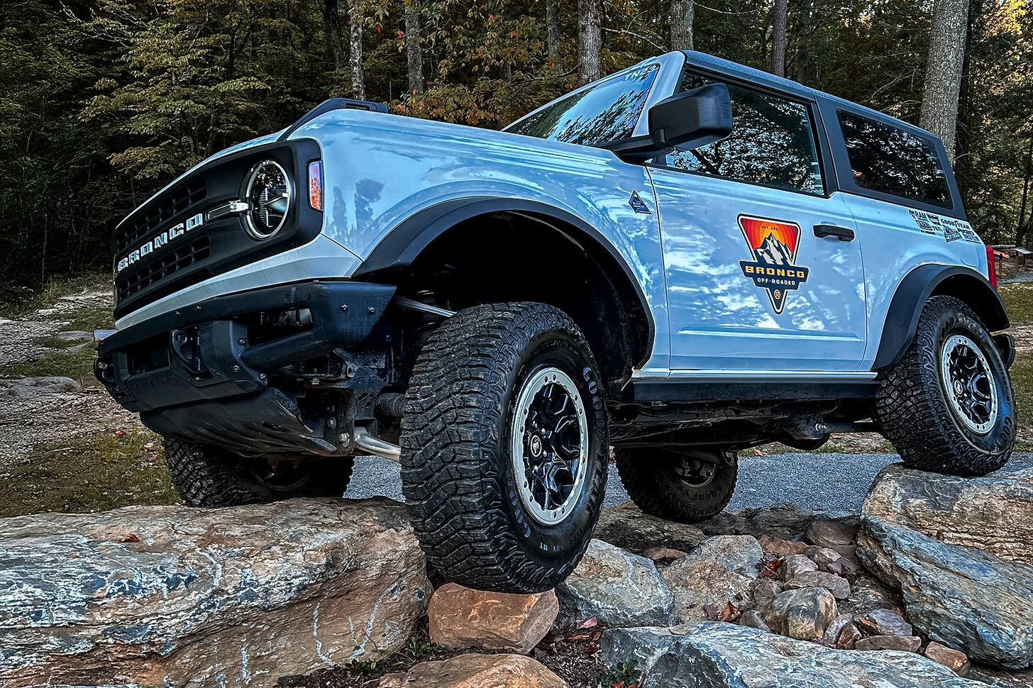 Ford Broncos driving on rocks at the Ford Bronco Off-Roadeo course in Tennessee
