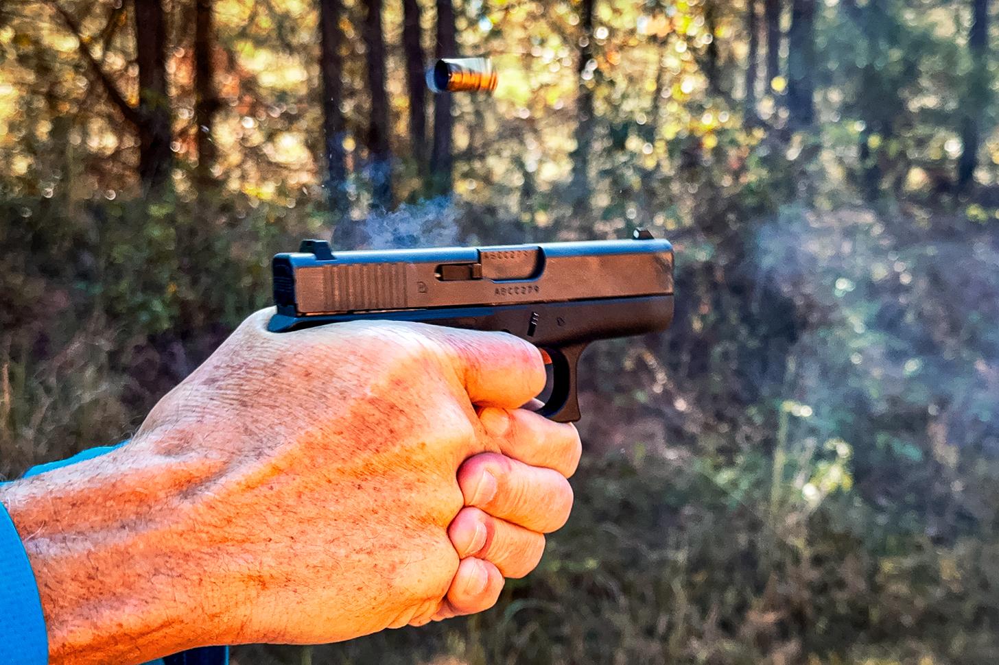 GLOCK 42 pistol being fired with ejected casing