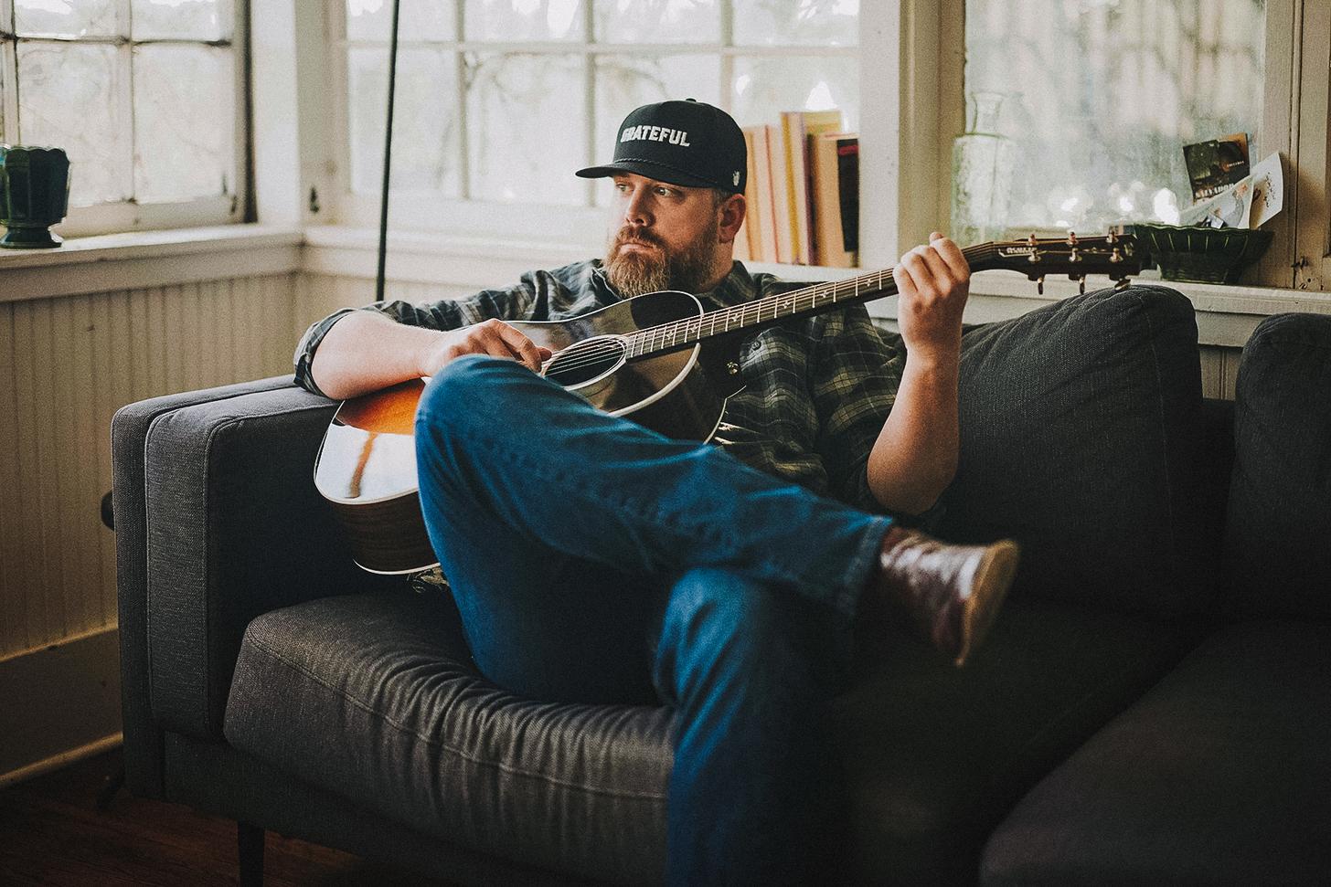 at home with his guitar