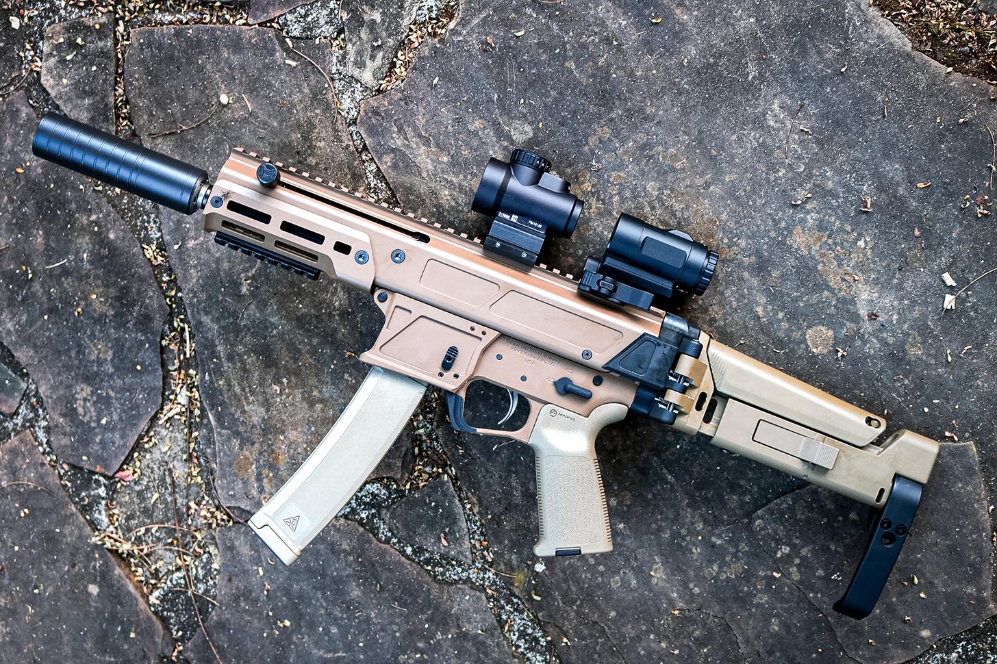 PSA JAKL 9 outfitted with a red dot and magnifier, suppressors, and pistol brace