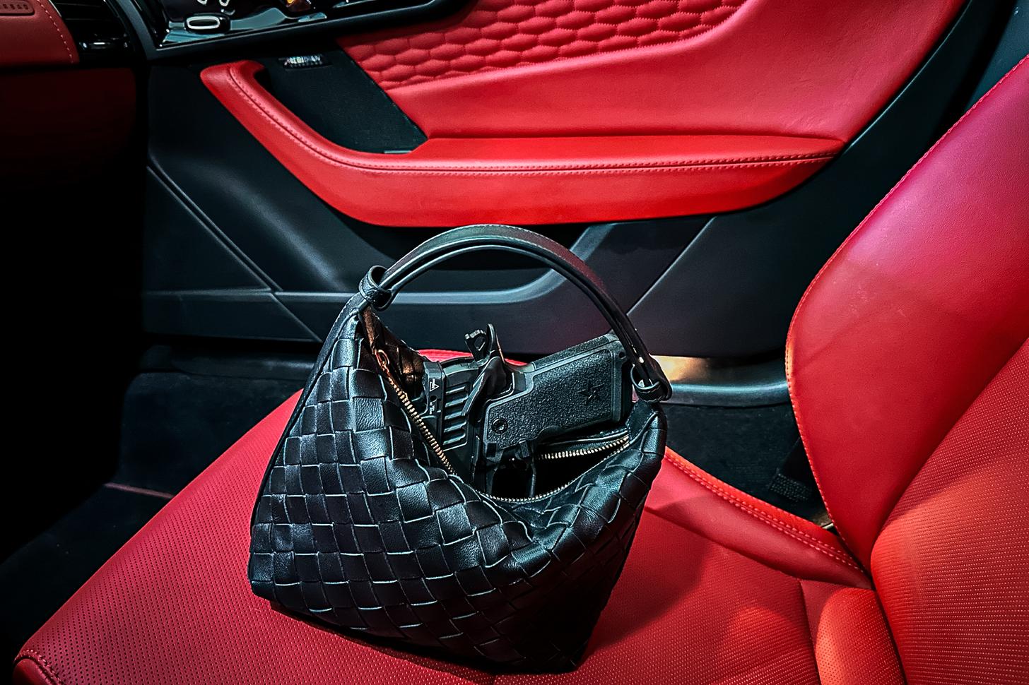 Staccato HD C3.6 in a purse on a car seat