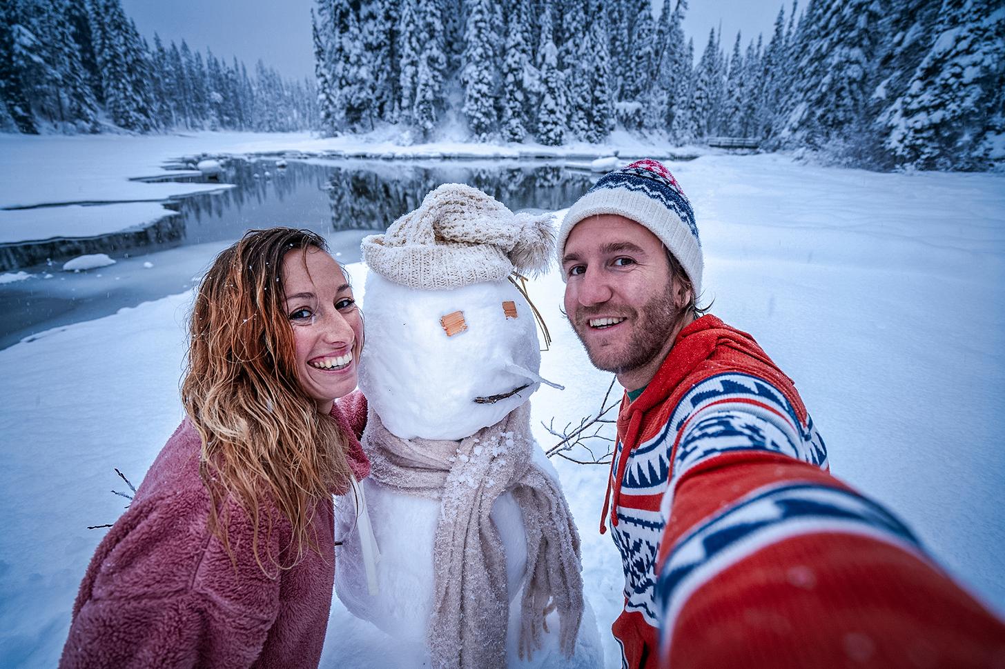 man and woman with snowman
