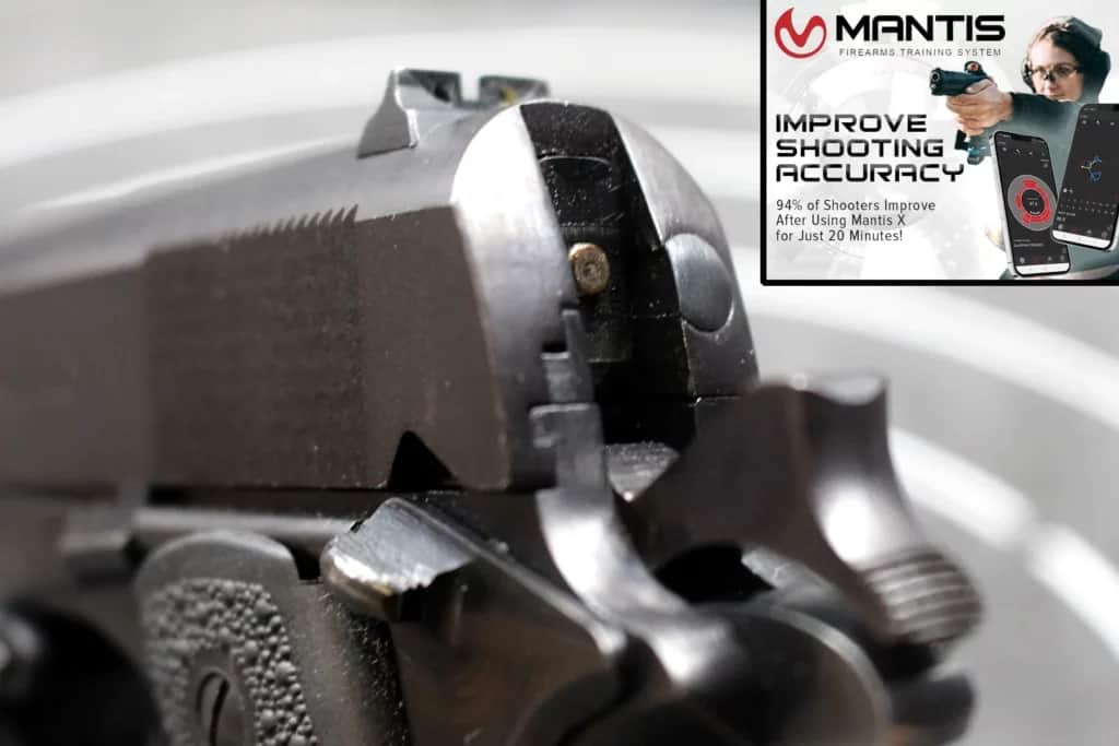 closeup of 1911 pistol fully cocked and off safe