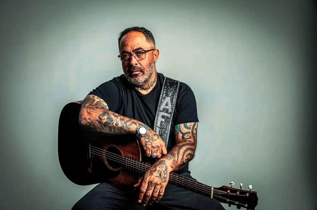 Aaron Lewis sitting with his guitar