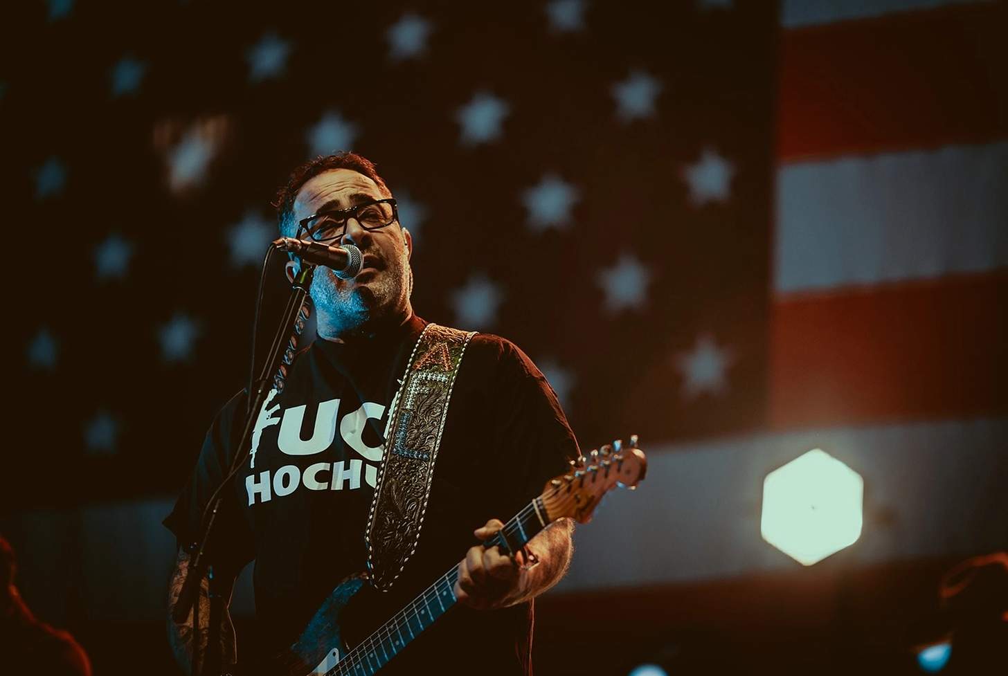 on stage singing and playing guitar