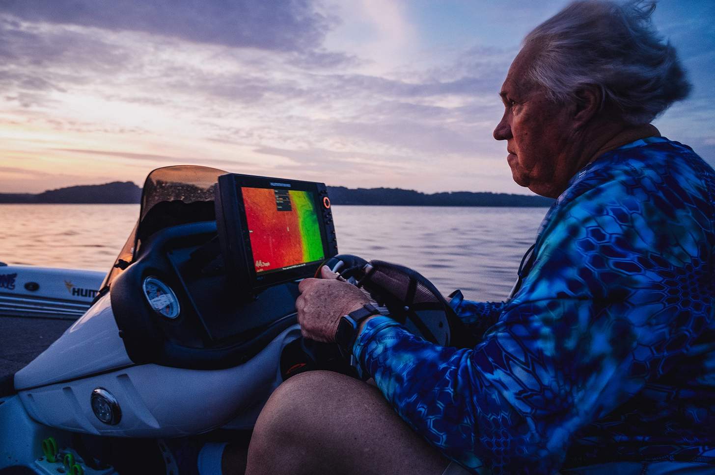 Eufaula Mayor Jack Tibbs poiloting a boat behind a sonar screen