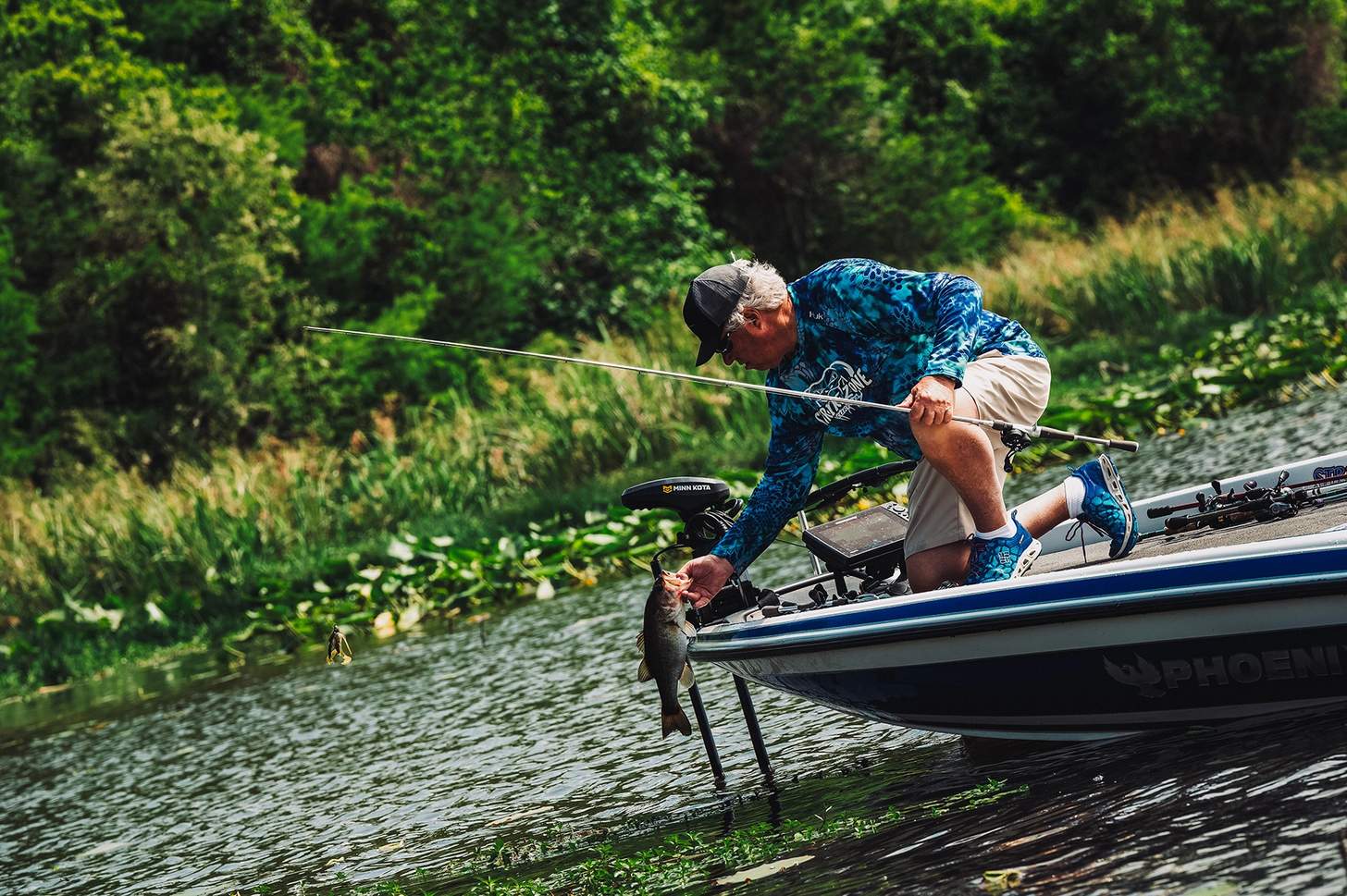 Jack Tibbs pulls a fish from the water