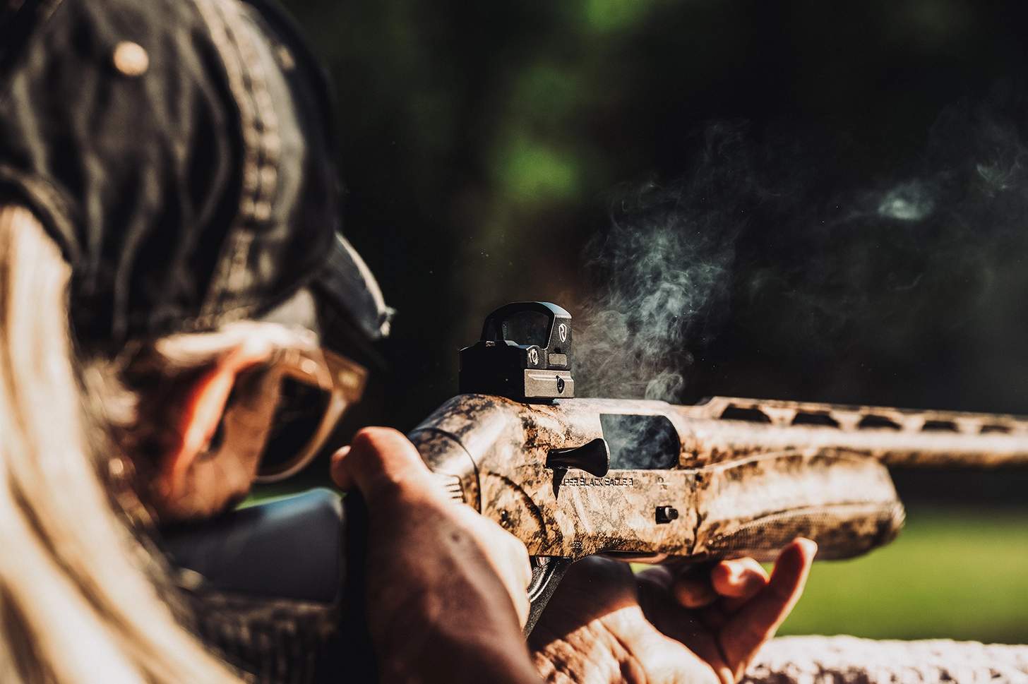 a woman shooting a benelli Super Black Eagle from a rest