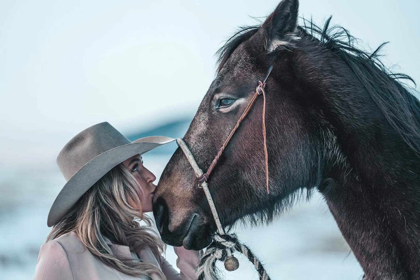 Amanda Caldwell kissing a horse's muzzle