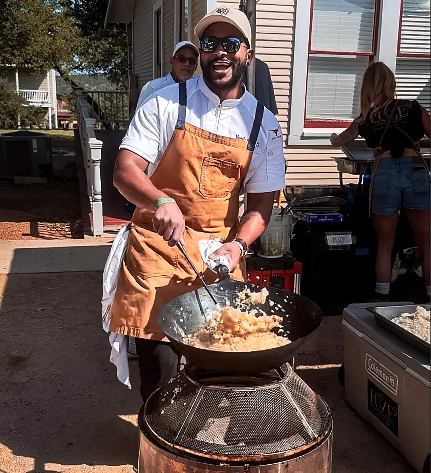 a man cooking with a large wok