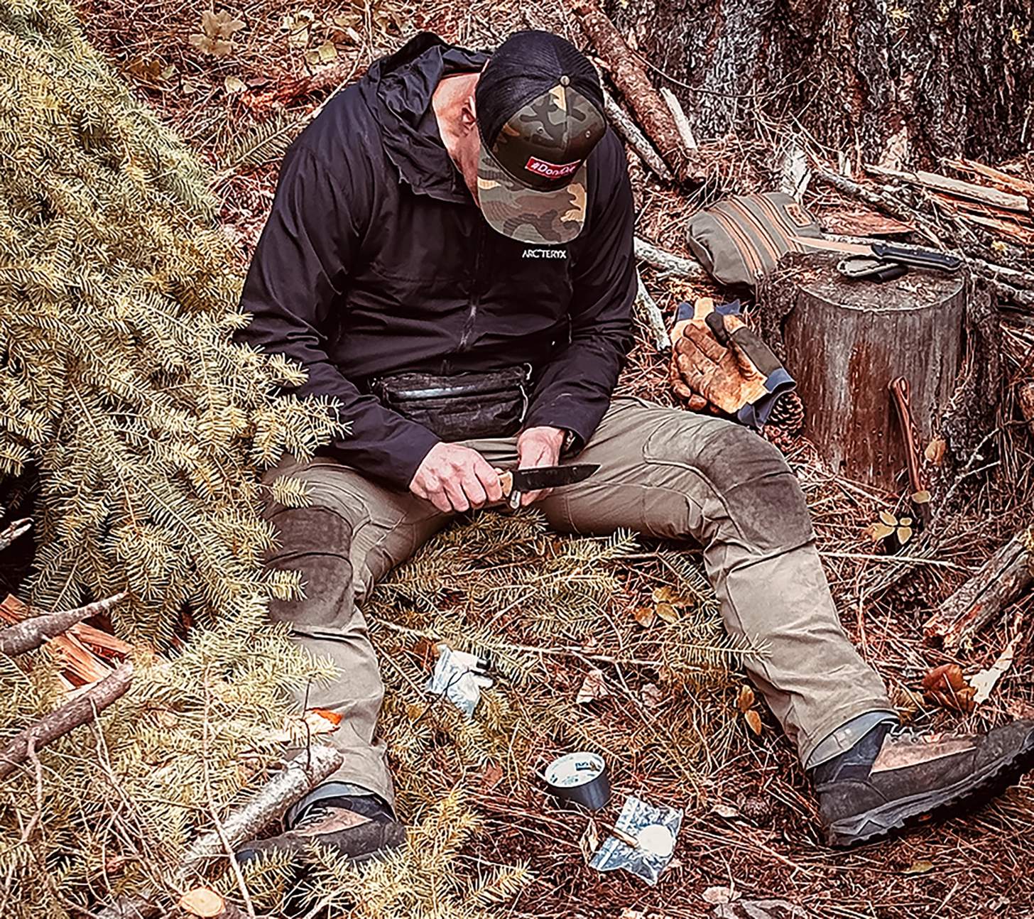John Barklow whittling in the wilderness
