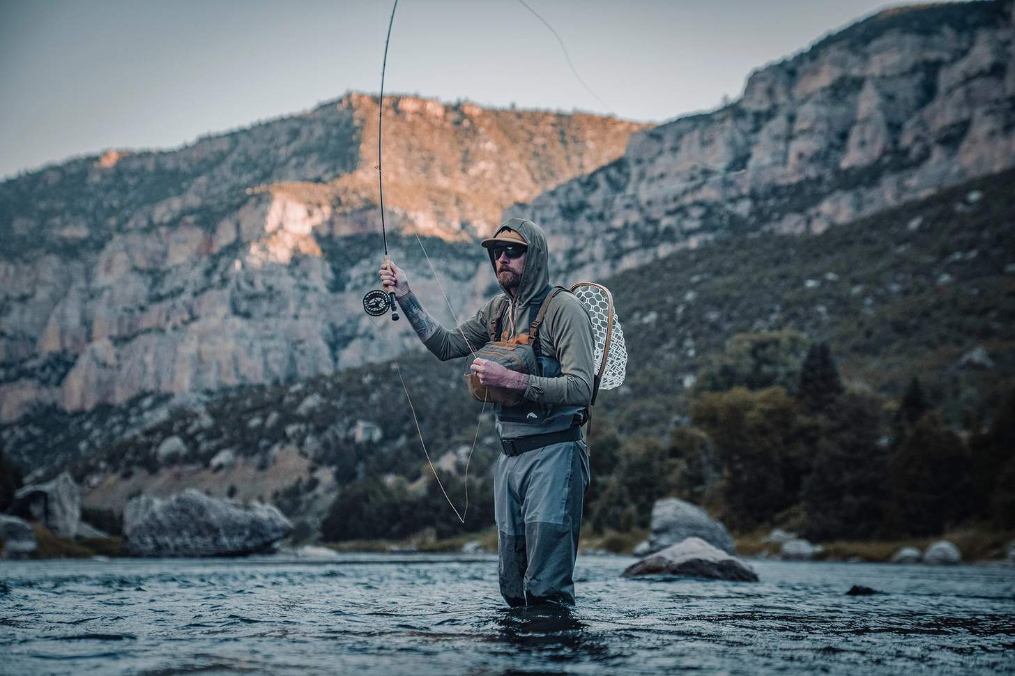 a fly angler wearing the Kifaru Steelhead Chest Rig with the Kifaru Hydro Harness