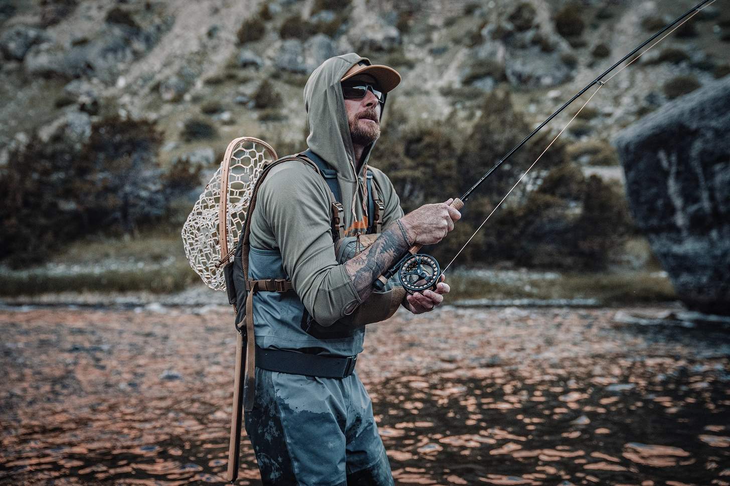 a fly angler wearing the Kifaru Steelhead Chest Rig with the Kifaru Hydro Harness