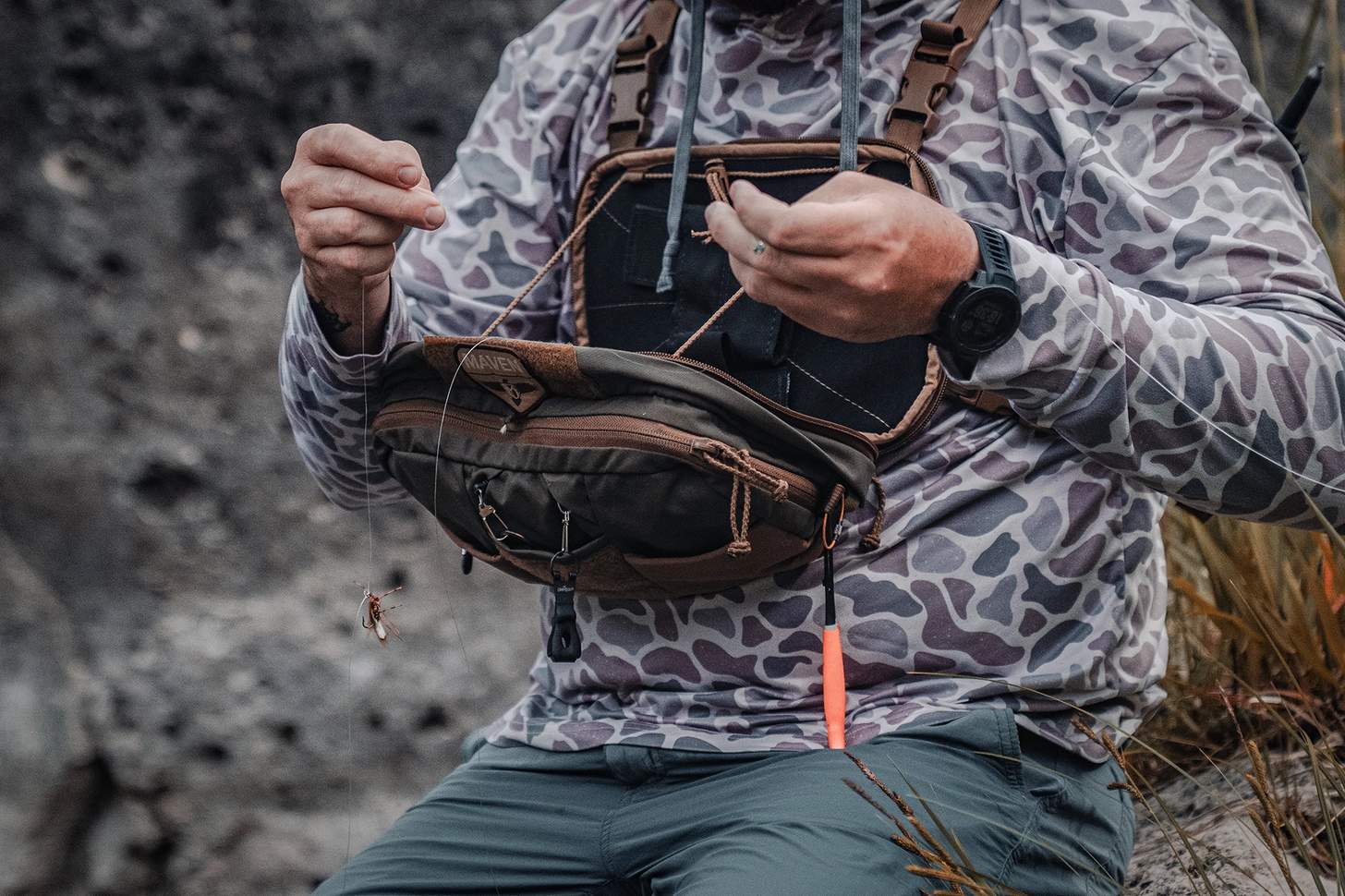 a fly angler wearing the Kifaru Steelhead Chest Rig with the Kifaru Hydro Harness with rear pouch open